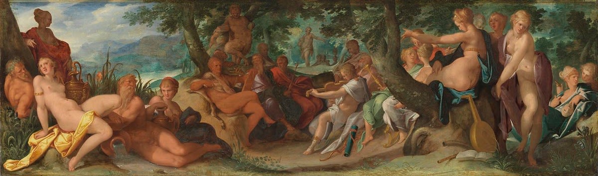 A mythological painting depicting a lively outdoor scene of gods, nymphs, and satyrs gathered in a lush forest clearing. The composition features nude and semi-nude figures reclining and interacting amid trees, foliage, and distant mountains under a bright sky. Central figures sit in relaxed poses, surrounded by others playing musical instruments, pouring wine, and engaging in conversation. Warm, earthy tones dominate the landscape, emphasizing the sensuality and harmony of the classical myth theme.