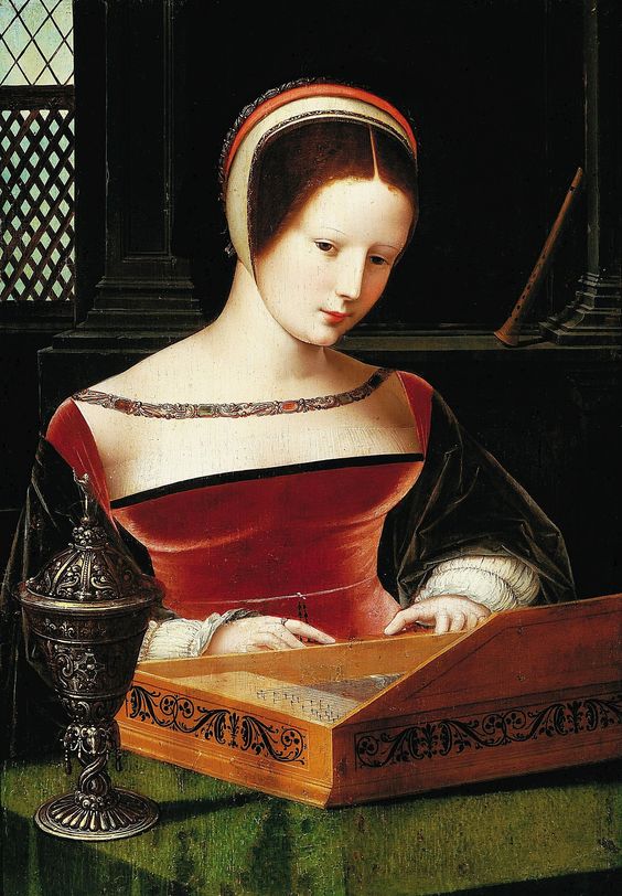 Renaissance-style oil painting of a young woman in a red velvet gown with black and white sleeves, seated indoors by a latticed window. She plays a small wooden clavichord with delicate focus. Her pale complexion and neatly arranged hair are framed by a white coif and red headband. A detailed ornate goblet stands beside her on a green-draped table. The background is dimly lit, emphasizing the soft light illuminating her face and dress.