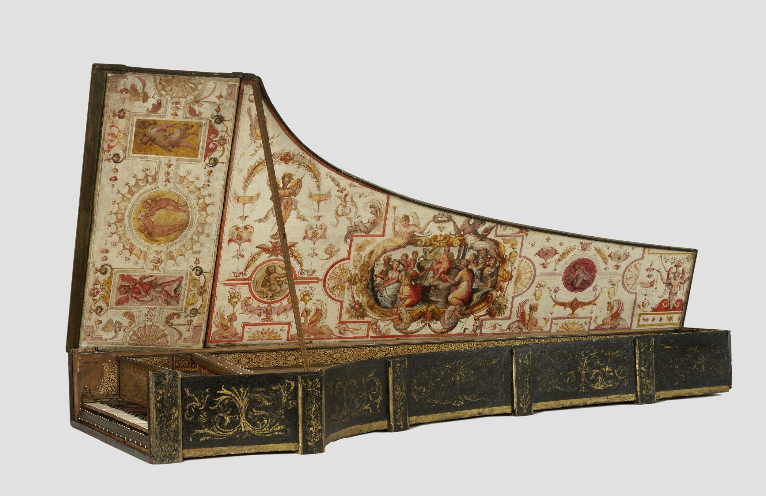 Ornate antique harpsichord with elaborate hand-painted decorations on the inside lid, featuring mythological and classical scenes surrounded by intricate floral and geometric patterns. The outer case is dark with gold detailing, creating a striking contrast with the richly painted interior.