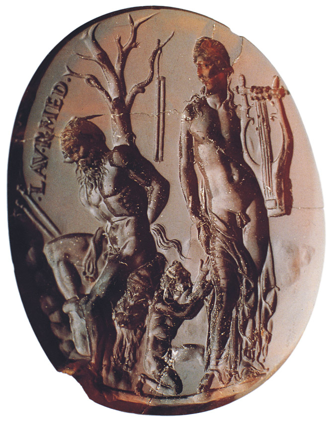 An ancient engraved gemstone depicting a mythological scene with three figures. On the left stands Marsyas, identifiable by his goat legs and horns, beside a tree with a shepherd’s staff hanging from it. At the center, a smaller figure, Olympus, kneels, reaching toward a tall, nude male figure on the right, Apollo, holding a lyre.