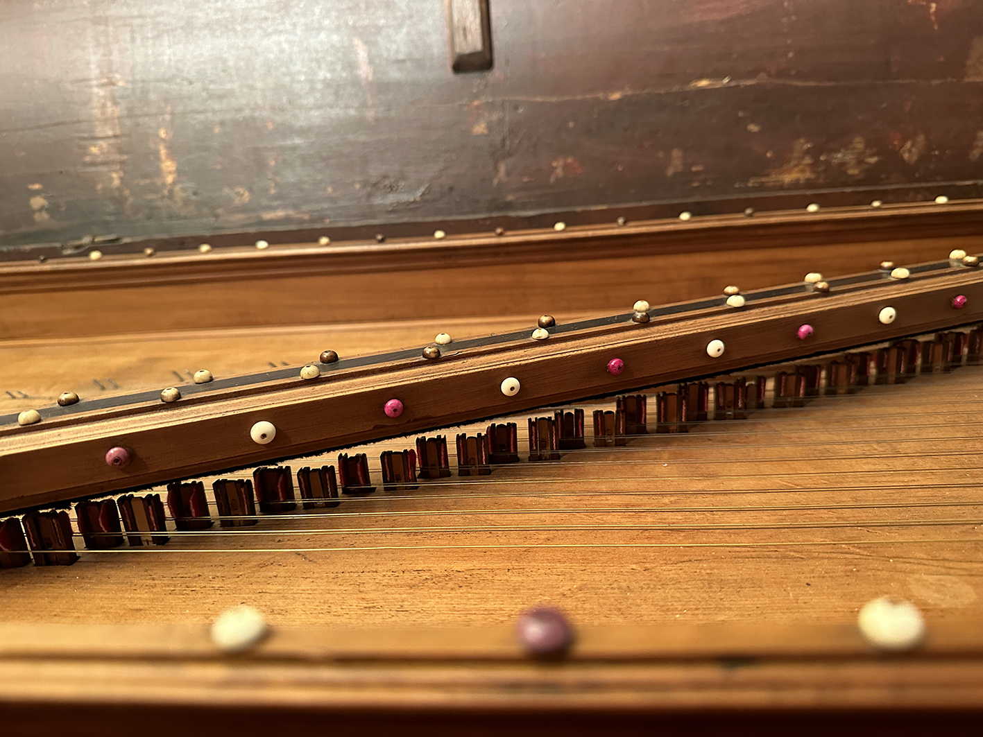 Close-up of the strings and ivory decoration of a virginal.