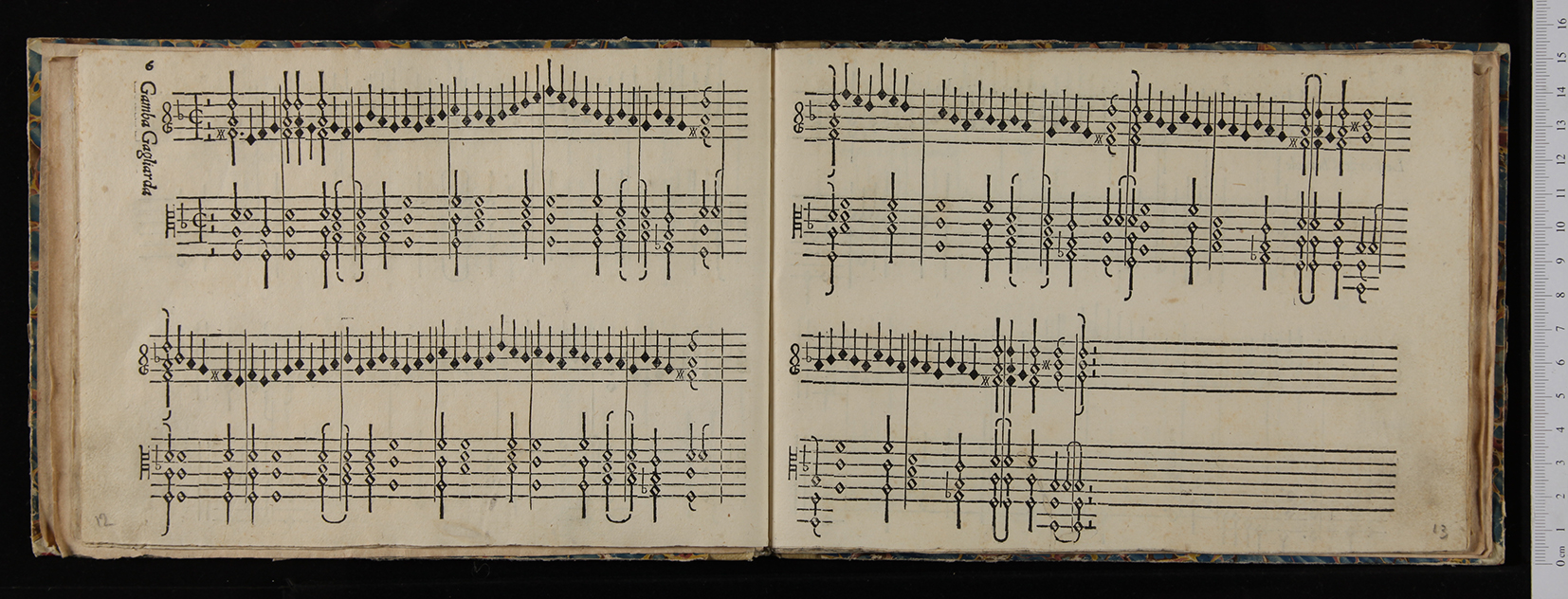 An open book showing printed keyboard tablature titled “Gamba gagliarda,” from Intabolatura nova (Venice, 1551). The two facing pages contain neatly engraved staves filled with black notation, chords, and ornaments, laid out clearly for early keyboard performance.