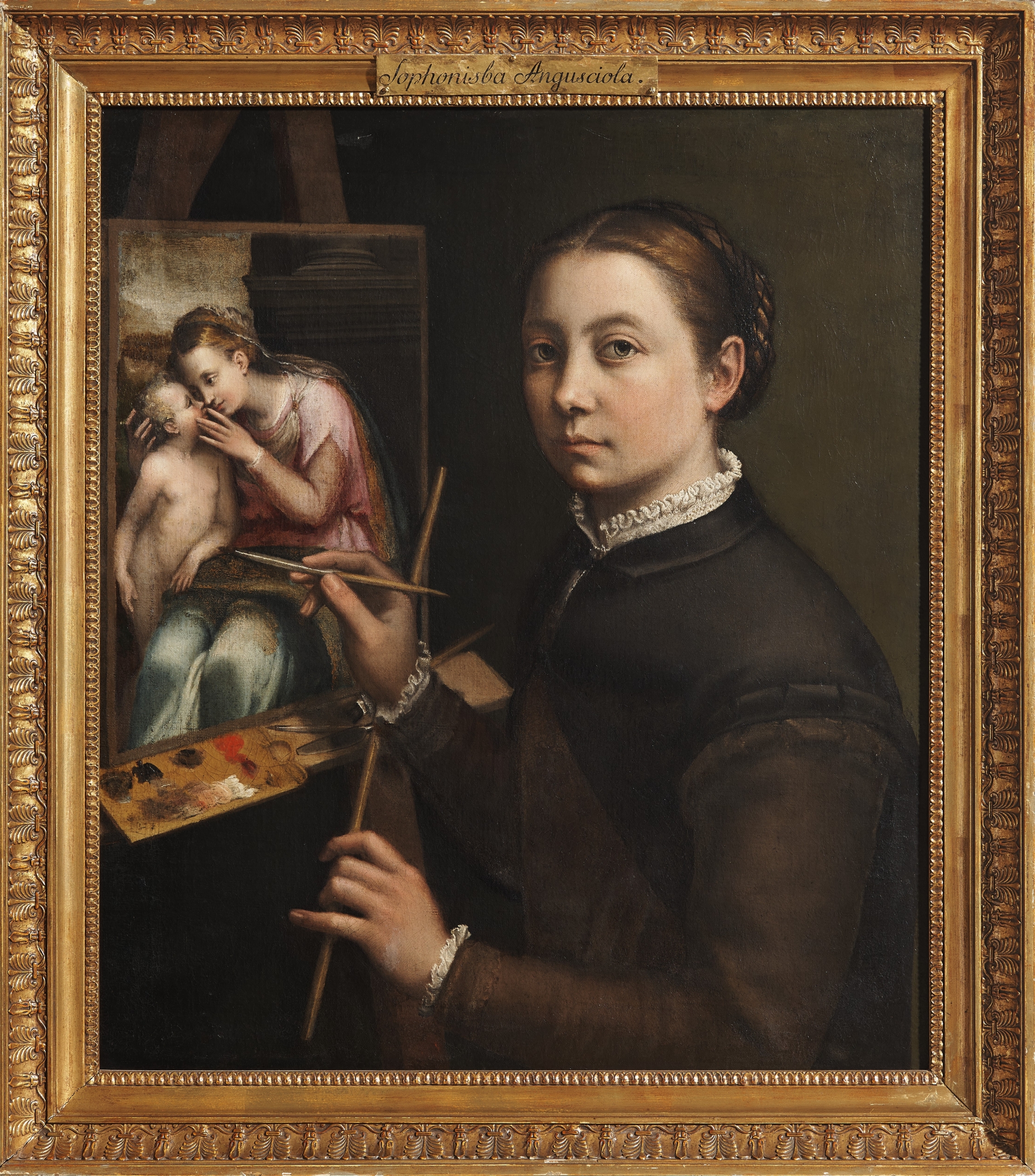 A self-portrait by Sofonisba Anguissola showing the artist at her easel, painting an image of the Madonna and Child. She gazes directly at the viewer with calm confidence, holding brushes and a palette. Dressed in a dark gown with a white lace collar, she stands before a simple green background, emphasizing her focus and artistry.